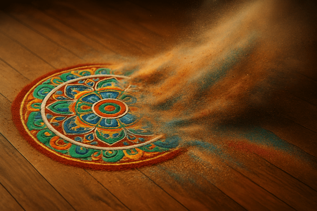 Mandala de arena de colores empezando a deshacerse por el viento sobre suelo de madera, símbolo de los vínculos que cambian pero dejan huella.