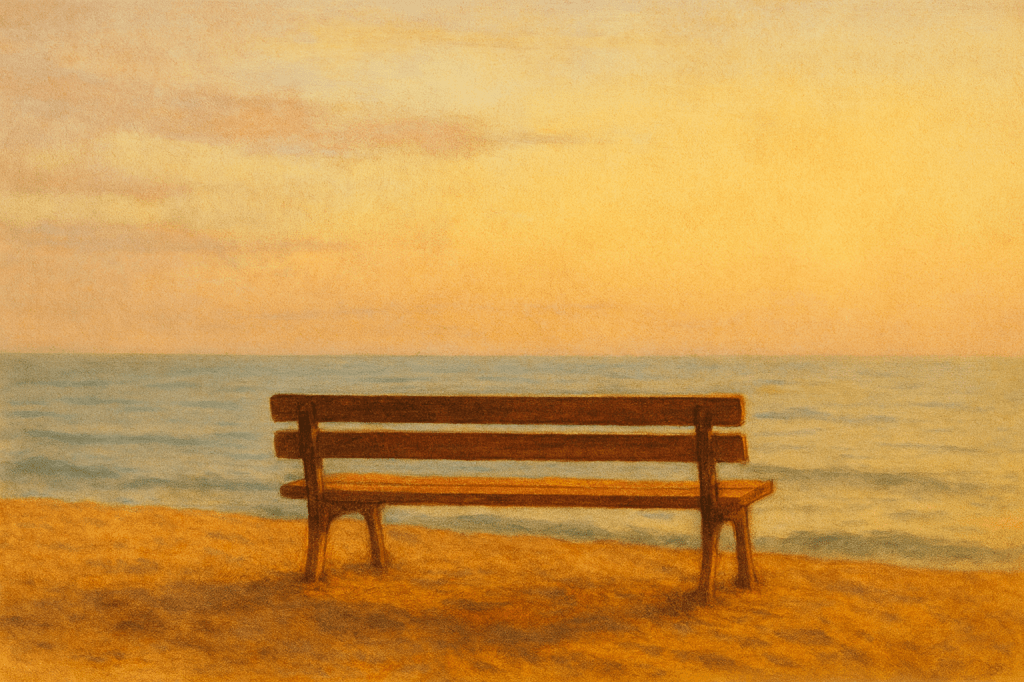 Banco vacío frente al mar durante el amanecer, con luz cálida y cielo suave